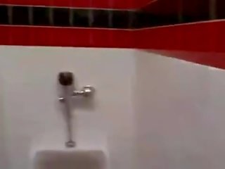 Cashier gives a random fellow a public bathroom blowjob